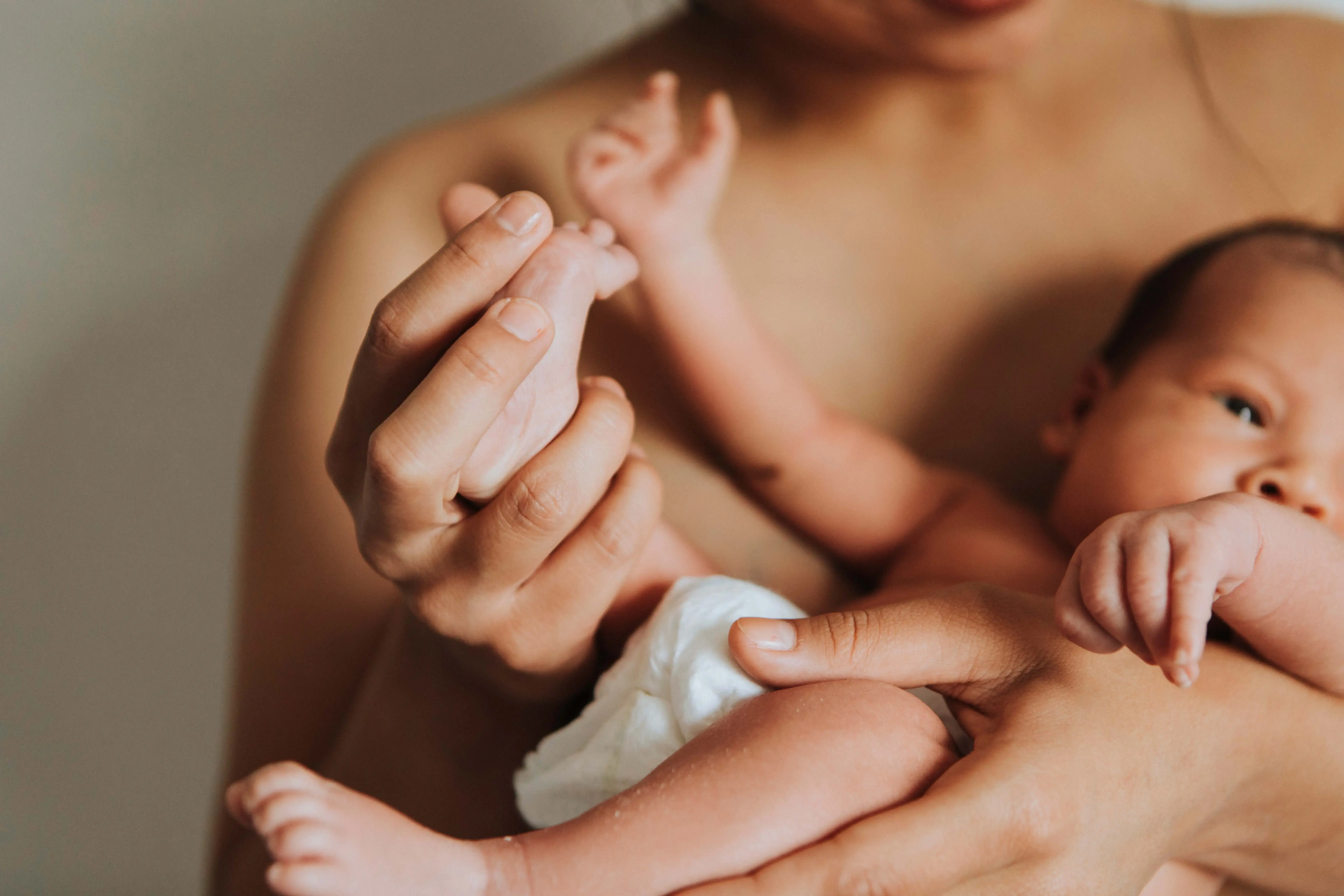 A mother holding a newborn baby in her arms